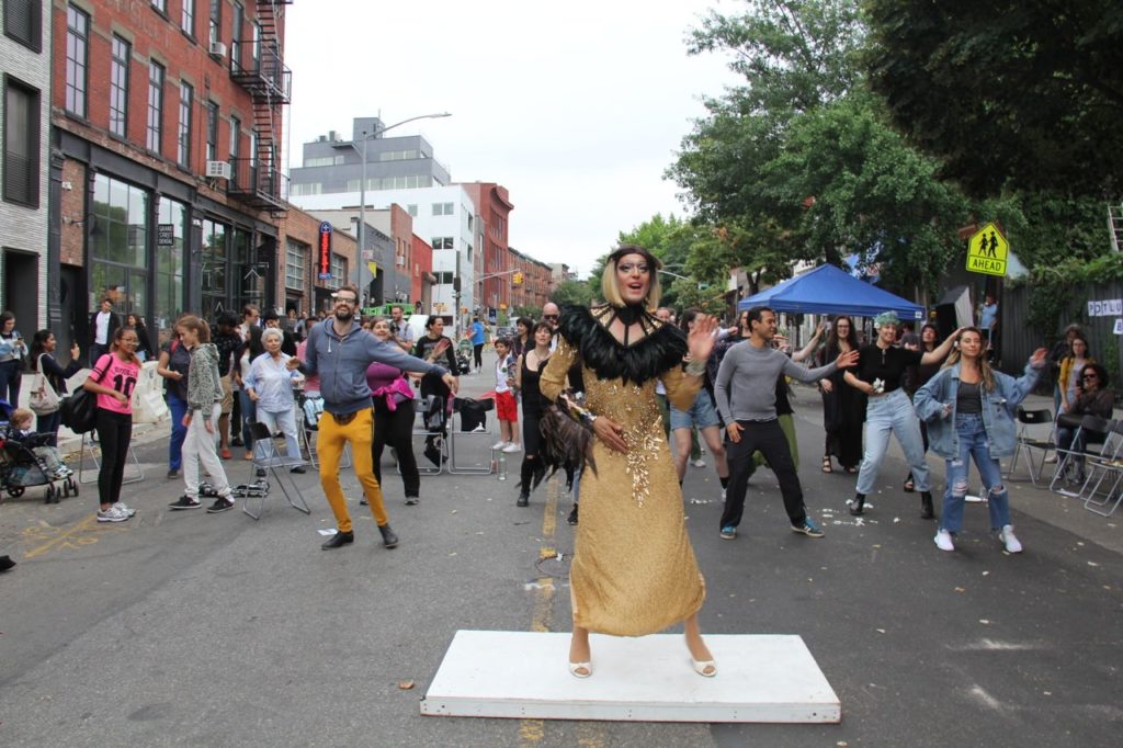 SOAK 2018 Block Party - 148 Mar leading zoomba class outside CAVE on Brooklyn street surrounded by happy followers