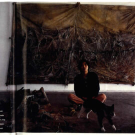 Naoki Iwakawa sitting in font of a canvas